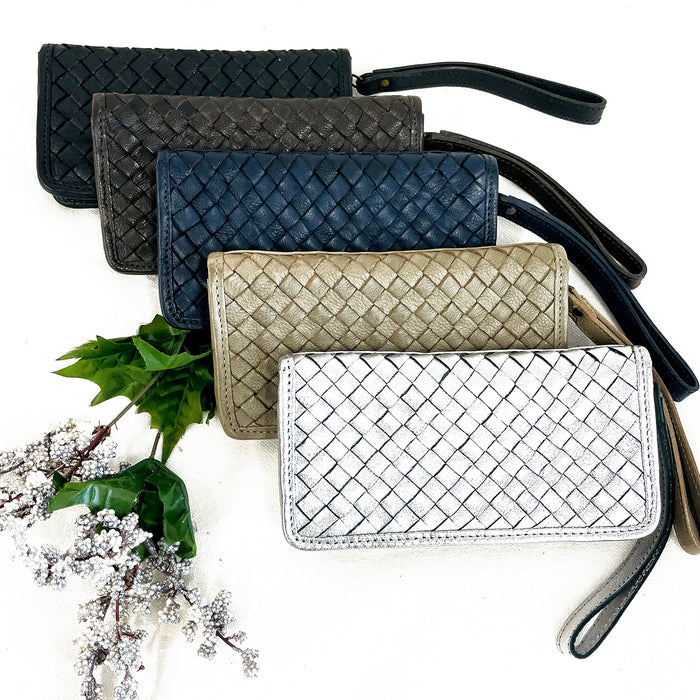 Wristlet wallet with outer zipper closure, interior zipper pocket and open pockets in metallics and black